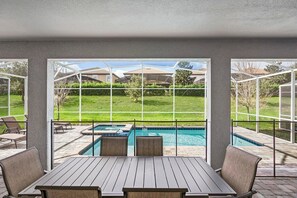Relax by the pool with a view of the surrounding landscape from this outdoor patio.