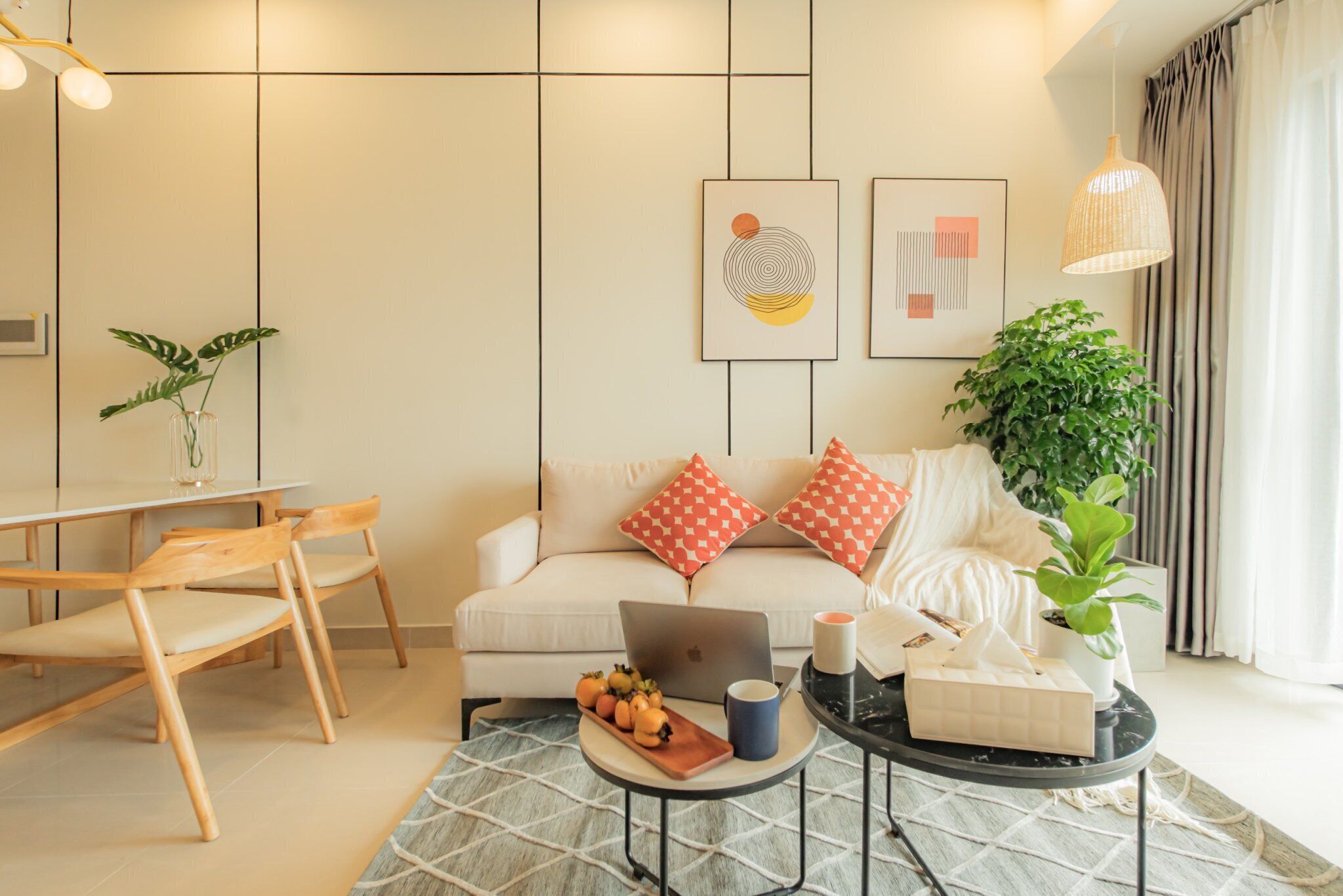 A modern living room with a sofa, coffee table, and dining area.
