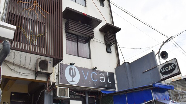 A building with a sign for 'Vcat Lounge' and a 'V-CAT' sign. - 1812 Vc Lodge (Manila)