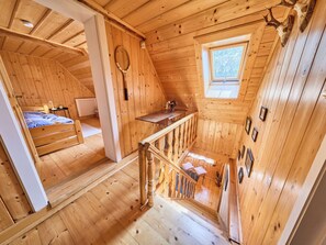A wooden cabin with a loft bedroom, a dining area, and a small kitchen. - Sunny Slope & Sauna by Interhome (Desná v Jizerských horách)