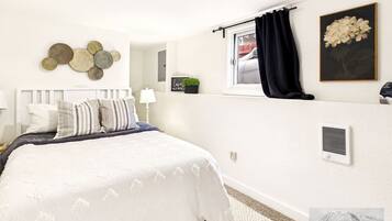 2 habitaciones, escritorio y tabla de planchar con plancha