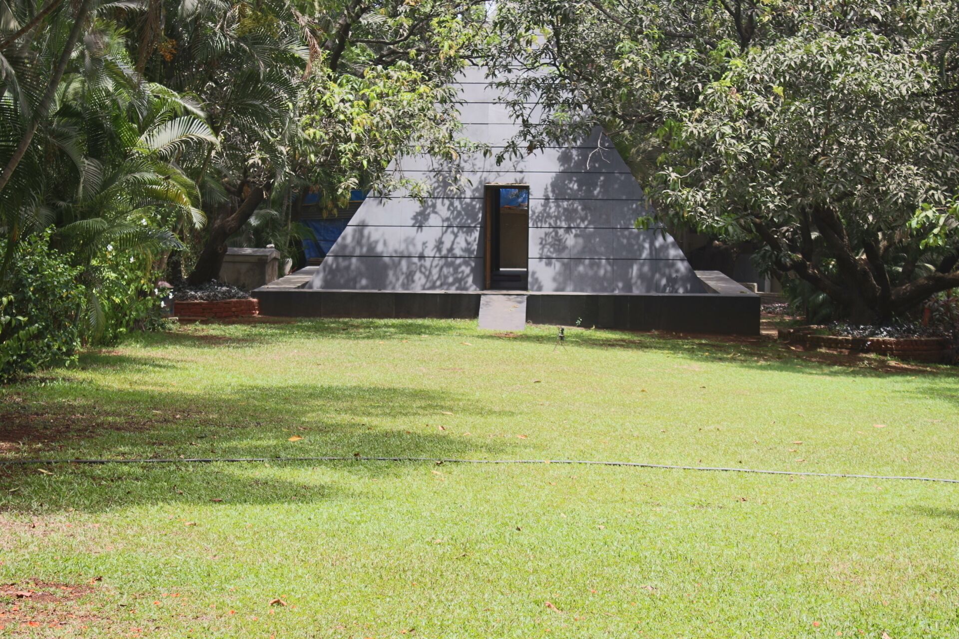 A modern building with a flat roof and a small entrance.