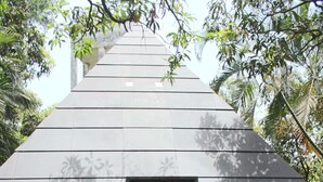A modern building with a sloped roof and a central entrance. - Outpost (Alibag)