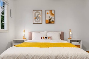 A bedroom with a bed, two bedside tables, a window, and two wall-mounted artworks. - 1803 Renton · 2b1b Sweet Suite @Renton 10 mins to SeaTac airport (Renton)