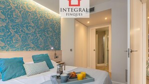 A hotel room with a bed, a tray with breakfast items, a shower, and a door leading to another room. - Modern Apartment, 2 Bedrooms, 150m from Beach, Central Palamós, with Parking, WiFi & A/C (Palamós)