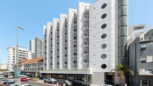 A modern multi-story building with balconies, a parking area, and a clear sky. - The Flamingo 708 (Cape Town)
