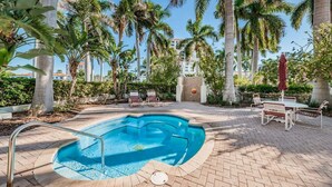 A swimming pool with a brick deck, surrounded by palm trees and lounge chairs. - Club Bahia Happiness Comes in (St. Petersburg)