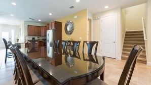 A spacious kitchen with a large island, wooden cabinets, and a stainless steel refrigerator. - Fantastic vacation with a private pool - FENCED POOL - Pet friendly (Kissimmee)
