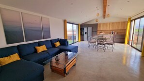 Relax in a spacious living area with a sofa, coffee table, and dining space.