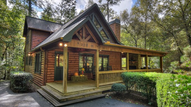 A log cabin with a porch, number 328, surrounded by trees. - Stoney Creek Retreat - Cherry Log, GA (Cherry Log)
