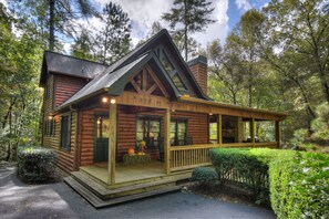 A log cabin with a porch, number 328, surrounded by trees. - Stoney Creek Retreat - Cherry Log, GA (Cherry Log)