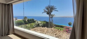 Enjoy breathtaking views of the coastal landscape from this room's expansive window.