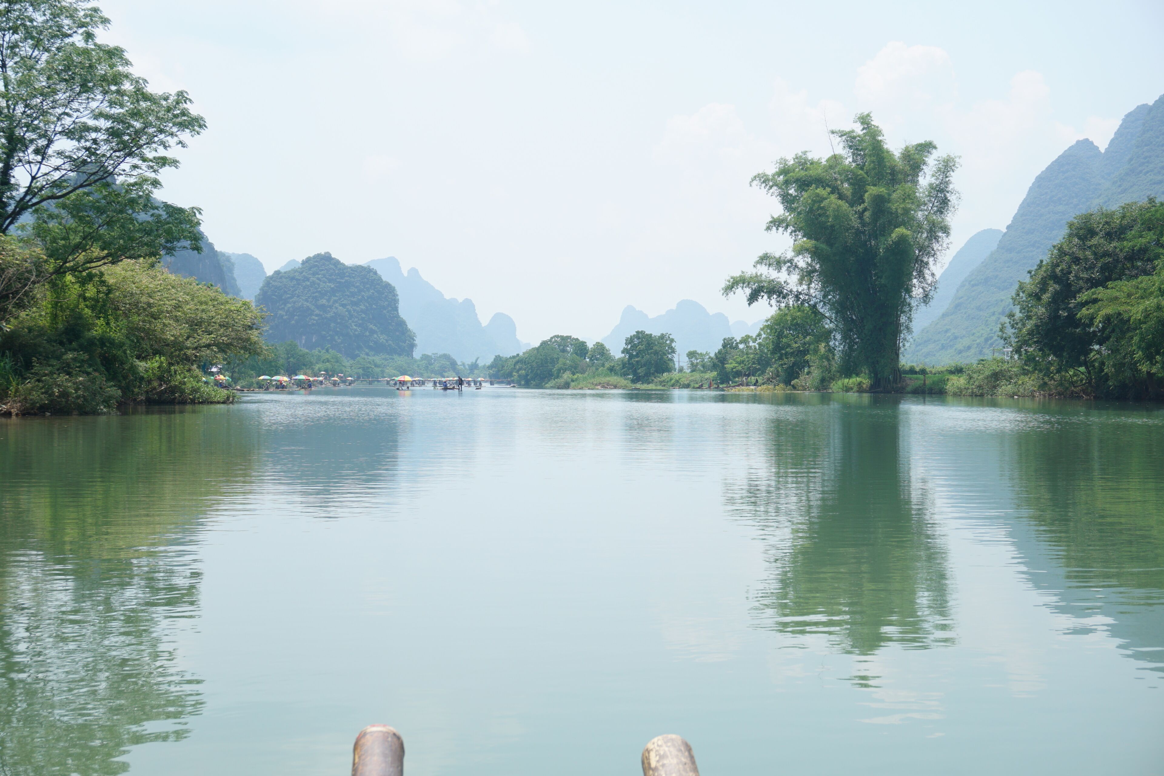 A calm river with mountains in the background.