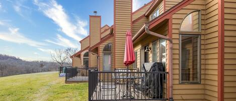 A house with a patio area, outdoor seating, and a chimney.