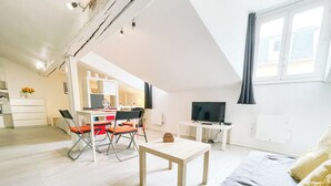 A modern living room with a dining area, a TV, and a sofa. - #EH  |  Le Rousseau 🤍 (Grenoble)