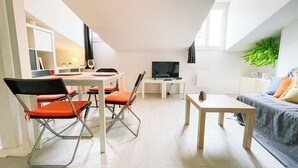 A modern, open-plan living space with a dining area, a TV, and a sofa. - #EH  |  Le Rousseau 🤍 (Grenoble)
