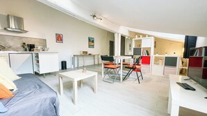 A compact living space with a kitchenette, a dining area, and a seating area with a bed. - #EH  |  Le Rousseau 🤍 (Grenoble)