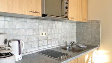 Fridge, microwave, stovetop, coffee/tea maker