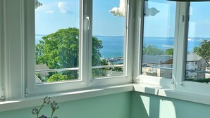 A room with a view of the sea and trees through large windows. - Villa Anna - App. 41 (Sassnitz)