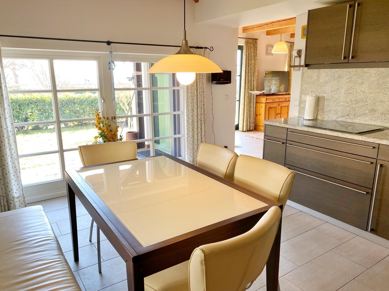 A modern kitchen with a dining area.