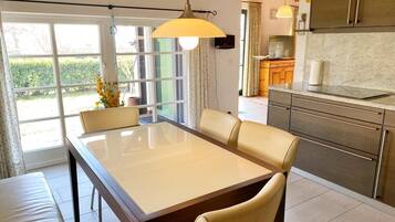 A modern kitchen with a dining area.