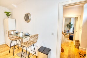 Enjoy meals in this cozy dining area with a glass-top table and two comfortable chairs.