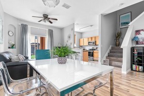 A modern kitchen with a microwave, oven, and wooden cabinets.