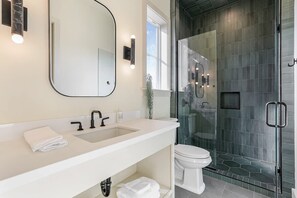 Bathtub, hair dryer, towels, shampoo