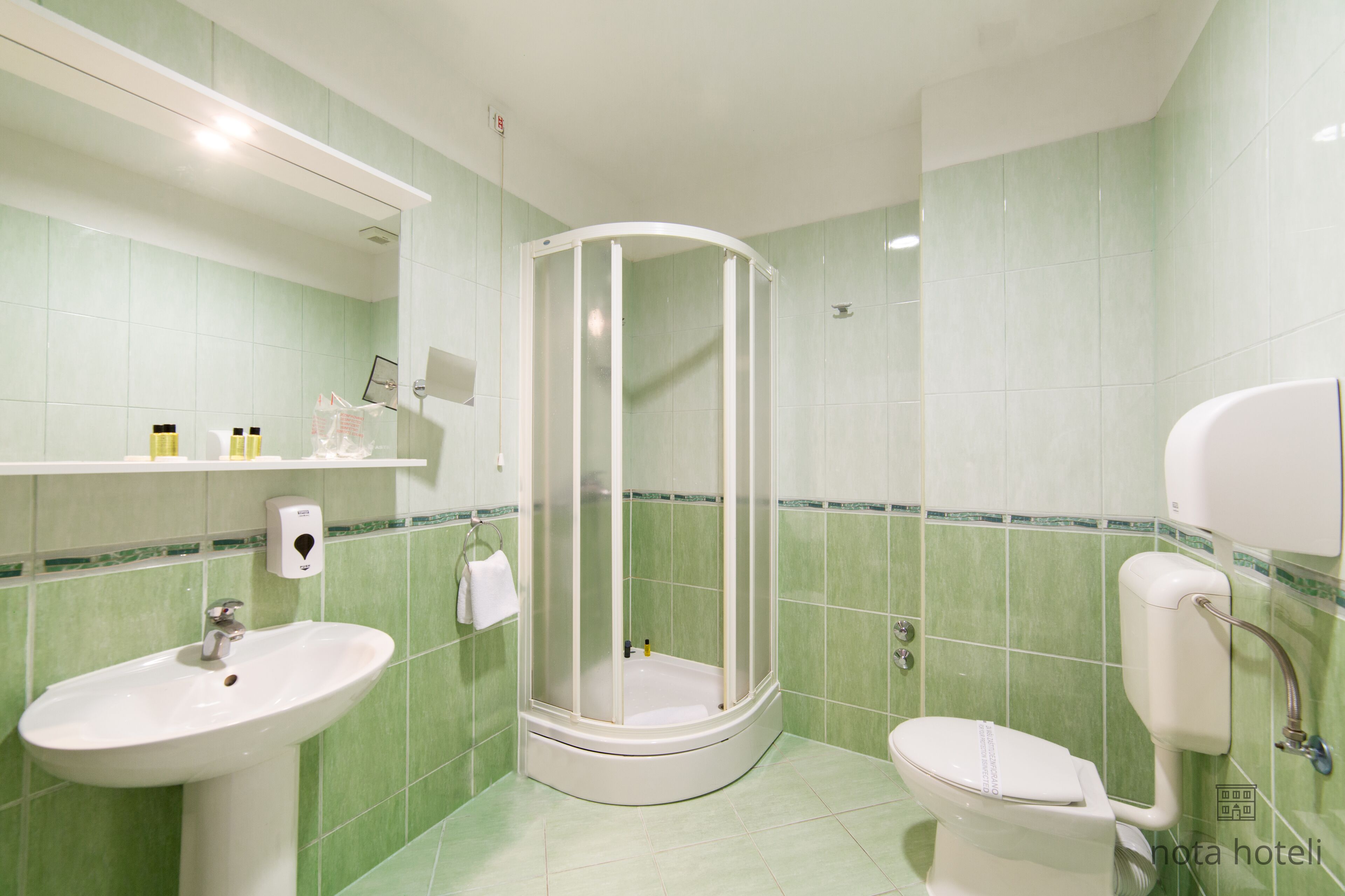 A bathroom with a sink, toilet, and shower.