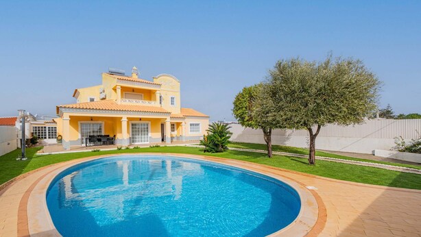 A residential property with a swimming pool, a two-story house, and a well-maintained lawn. - Villa Coelha - Table tennis and Pool Table (Guia)