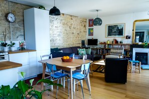Relax in a stylish living space with a dining area, comfortable seating, and a cozy fireplace.