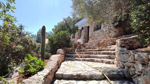 A stone staircase leading up to a building with a stone wall and a cactus in the foreground. - Villa Marinus- Private Pool And Breathtaking Sea View (Corsano)