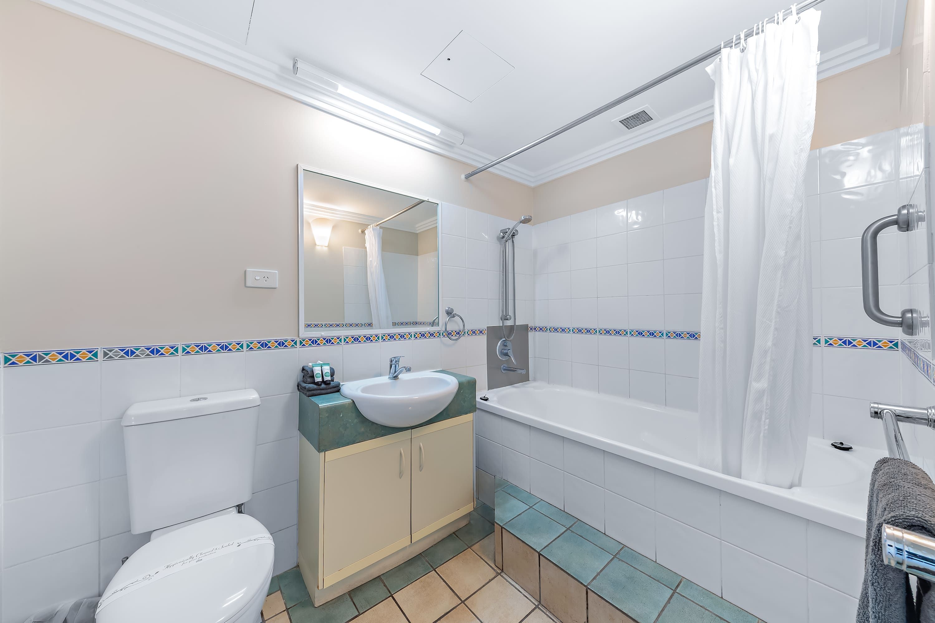 A bathroom with a toilet, sink, bathtub, and shower.