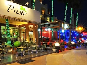 Dine al fresco at Presta, where tables and chairs invite you to enjoy a meal under the stars.