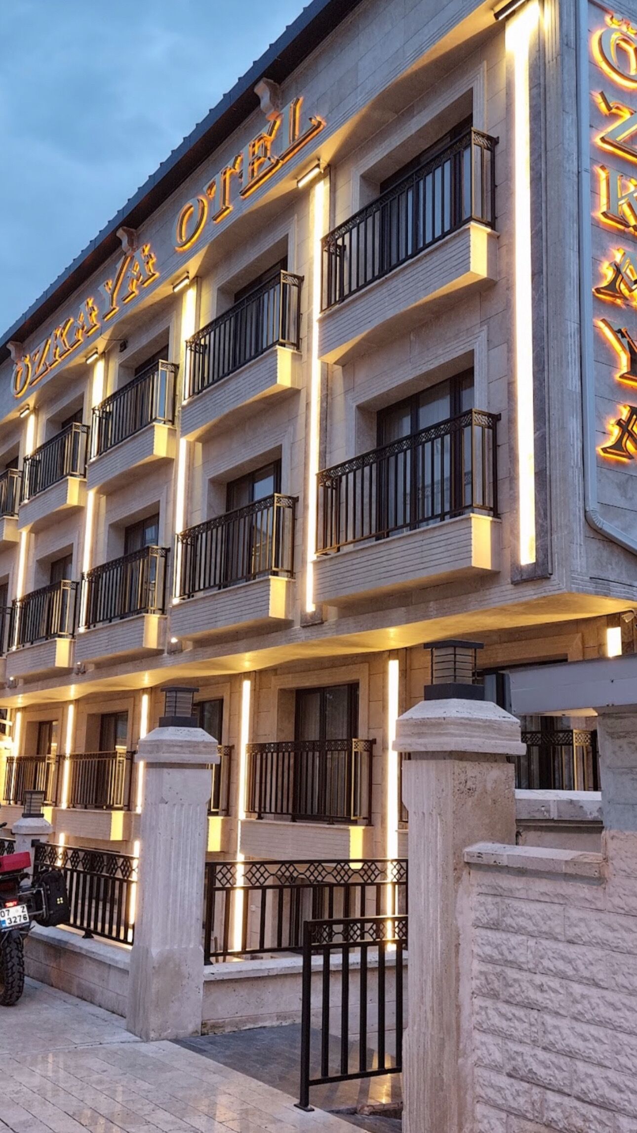 A multi-story hotel with balconies and a prominent sign.