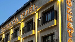 A multi-story hotel with balconies and illuminated signage. - Ozkaya Otel (Sivas)