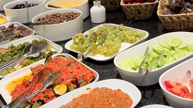 A buffet with various dishes including salads, fruits, and cooked vegetables. - Ozkaya Otel (Sivas)