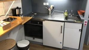 A compact kitchen with a stove, oven, dishwasher, and sink. - L'Idéal en Charteuse (Saint-Pierre-de-Chartreuse)
