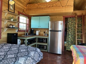 Enjoy a comfortable living space with a compact kitchen, bed, and seating area.