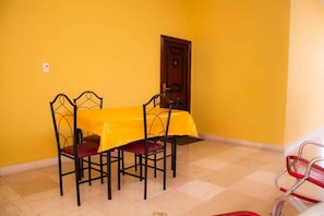 Enjoy meals in this cozy dining area with a table for four and a checkered floor.