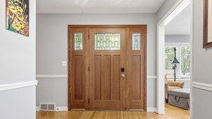 A wooden door with a glass panel, a white wall, and a wooden floor. - 1419-Walk to Mayo St Mary-Ritabnb Cheerful 5br+6baths,1 min walk to St.Marys (Rochester)