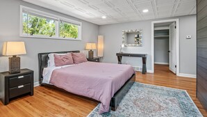 A bedroom with a bed, nightstands, a desk, a mirror, and a walk-in closet. - 1419-Walk to Mayo St Mary-Ritabnb Cheerful 5br+6baths,1 min walk to St.Marys (Rochester)