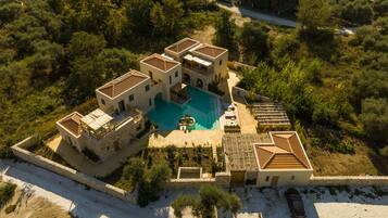 Una amplia villa con piscina, varias habitaciones y un patio.
