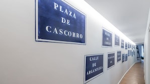 A hallway with signs indicating 'Plaza de Cascorro' and 'Calle de Arganzuela'. - 1)The Heart Of The City, Sol, By MoNARO (Madrid)