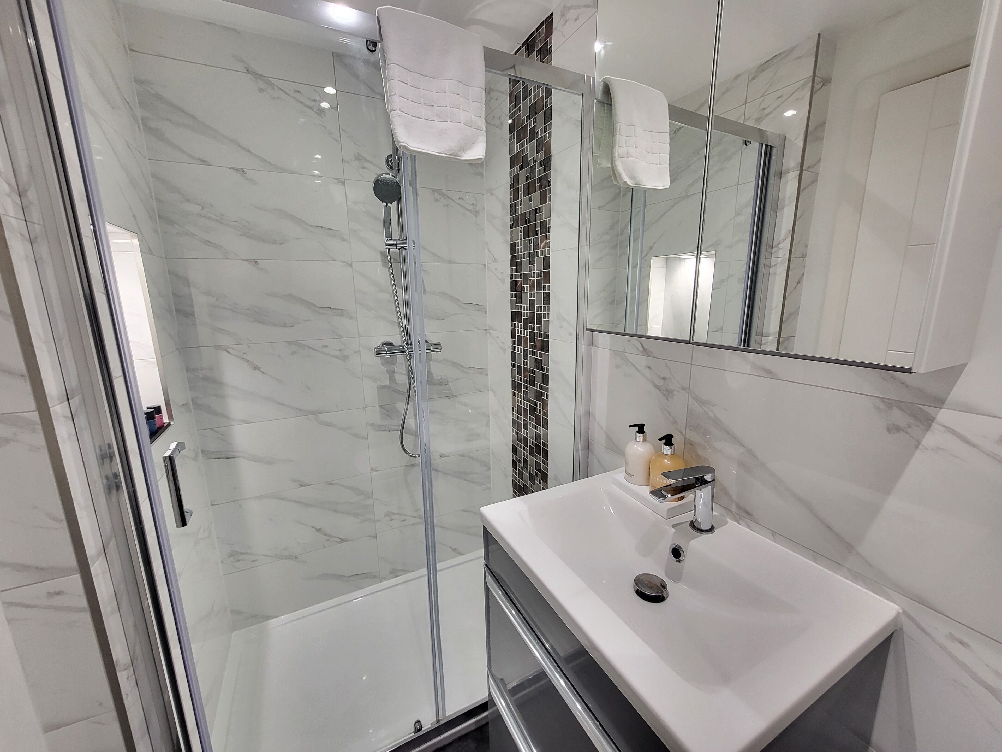 Shower, hair dryer, towels, soap