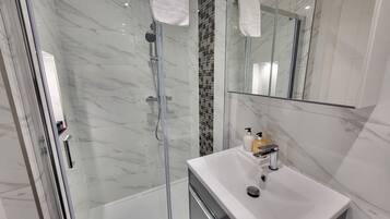 Shower, hair dryer, towels, soap