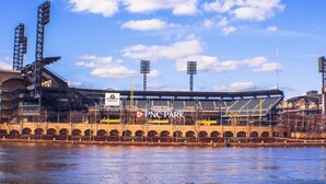 A stadium with a large seating area, a bridge, and a river in the foreground. - California Ave Quarters - Modern 1BR - EZ Parking (Pittsburgh)