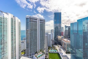 A high-rise building complex with multiple residential towers, a central building with a unique facade, and a rooftop pool area.