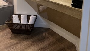 A modern bathroom with a large mirror, two sinks, a shower, and a basket of towels. - Foxburg Inn (Foxburg)