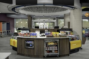 A self-service beverage station with a refrigerated display and a coffee machine. - Tru by Hilton North Richland Hills DFW West (North Richland Hills)